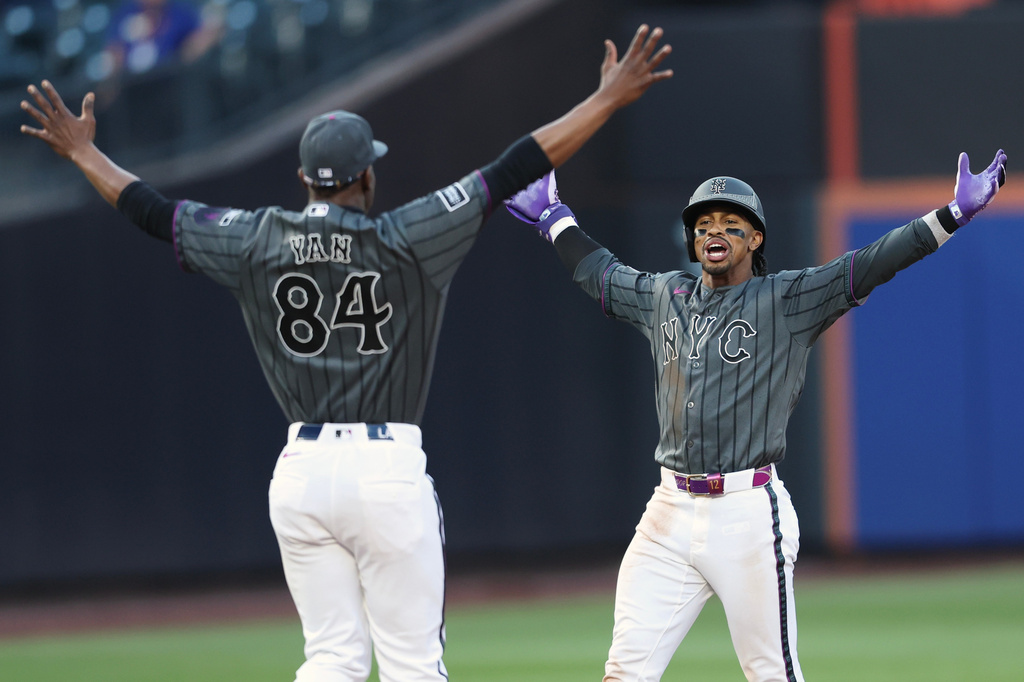New York Mets' Francisco Lindor celebrates his game winning base hit with pitcher Jefry Yan (84) during the ninth inning of a baseball game against the Washington Nationals, Saturday, Aug. 15, 2026, in New York. (AP Photo/Heather Khalifa)