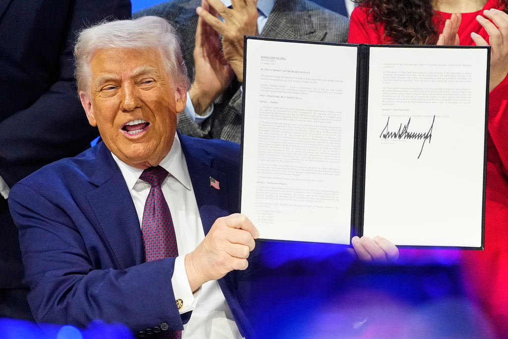 President Donald Trump holds the charter during a signing ceremony on his Board of Peace initiative at the Annual Meeting of the World Economic Forum in Davos, Switzerland, Thursday, Jan. 22, 2026. (AP Photo/Markus Schreiber)