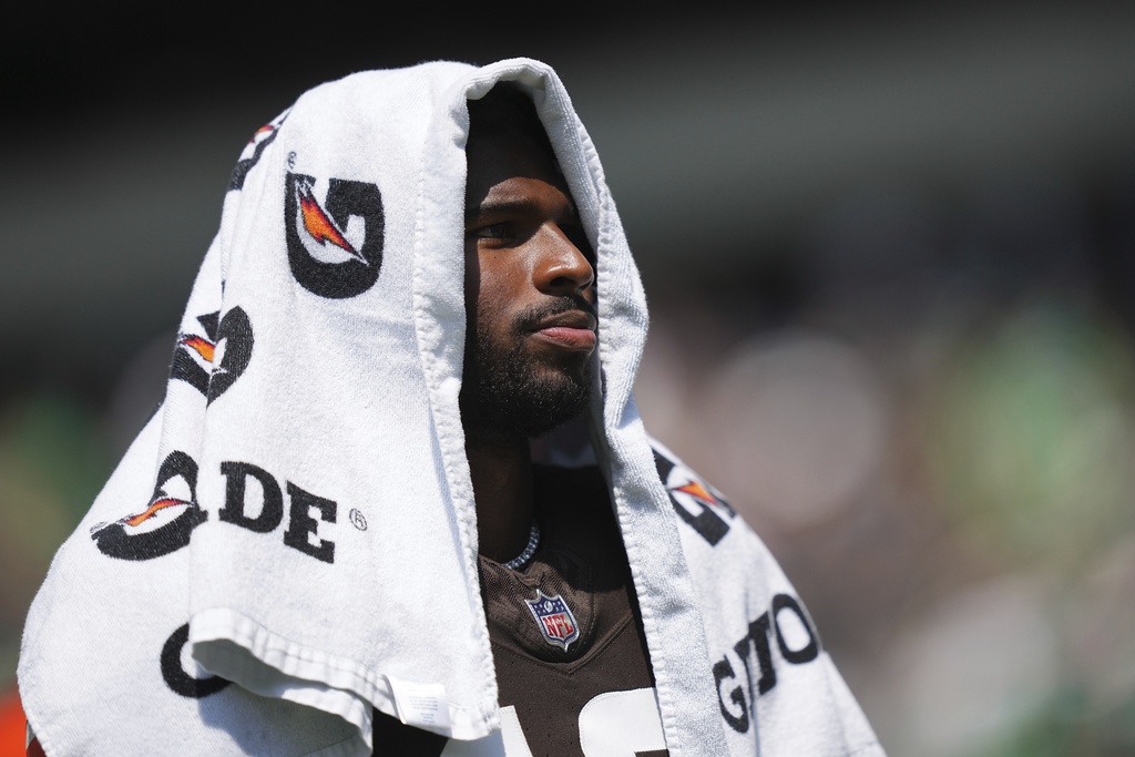 Cleveland Browns quarterback Shedeur Sanders covers his head during the first half of an NFL preseason football game against the Philadelphia Eagles on Saturday, Aug. 16, 2025, in Philadelphia. (AP Photo/Matt Rourke)