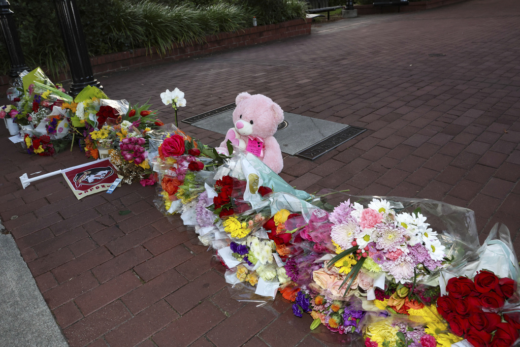 FILE - An impromptu memorial of flowers and other items laid near the center of the Florida State campus in sight of the Student Union building, Tallahassee, Fla., April 17, 2025. (AP Photo/Gary McCullough, File)