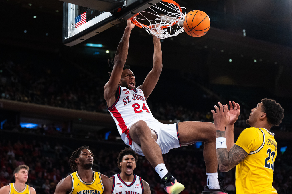 St. John forward Zuby Ejiofor (24) dunks during the second half of an NCAA college basketball exhibition game against Michigan, Saturday, Oct. 25, 2025, in New York. (AP Photo/Angelina Katsanis)