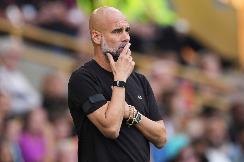 FILE - Manchester City's head coach Pep Guardiola concentrates during the English Premier League soccer match between Wolverhampton Wanderers and Manchester City at Molineux Stadium, Wolverhampton, England, on Aug. 16, 2025. (AP Photo/Dave Shopland, File)