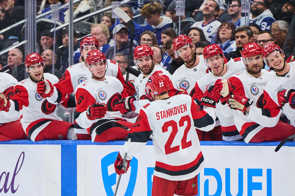 Carolina Hurricanes' Logan Stankoven (22) celebrates his game winning goal against the Toronto Maple Leafs during the third period of an NHL hockey game in Toronto, on Sunday, Nov. 9, 2025. (Sammy Kogan/The Canadian Press via AP)