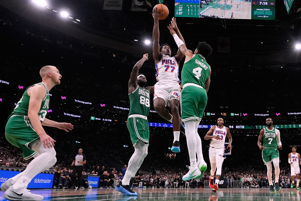 Philadelphia 76ers guard VJ Edgecombe (77) drives to the basket against Boston Celtics guard Anfernee Simons (4) during the second half of an NBA basketball game, Wednesday, Oct. 22, 2025, in Boston. (AP Photo/Charles Krupa)