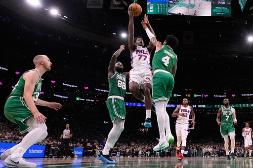 Philadelphia 76ers guard VJ Edgecombe (77) drives to the basket against Boston Celtics guard Anfernee Simons (4) during the second half of an NBA basketball game, Wednesday, Oct. 22, 2025, in Boston. (AP Photo/Charles Krupa) Philadelphia 76ers guard VJ Edgecombe (77) drives to the basket against Boston Celtics guard Anfernee Simons (4) during the second half of an NBA basketball game, Wednesday, Oct. 22, 2025, in Boston. (AP Photo/Charles Krupa)