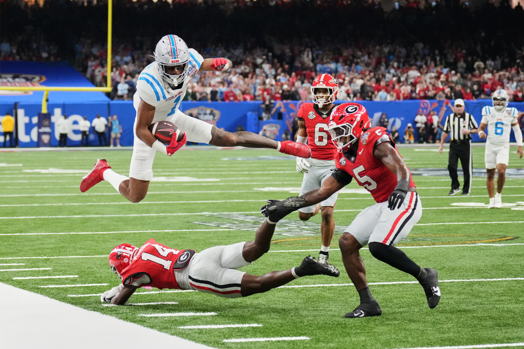 Mississippi wide receiver De'Zhaun Stribling (1) leaps over Georgia defensive back Adrian Maddox (14) in the second half of the Sugar Bowl NCAA college football playoff quarterfinal game in New Orleans, Thursday, Jan. 1, 2026. (AP Photo/Mathew Hinton)