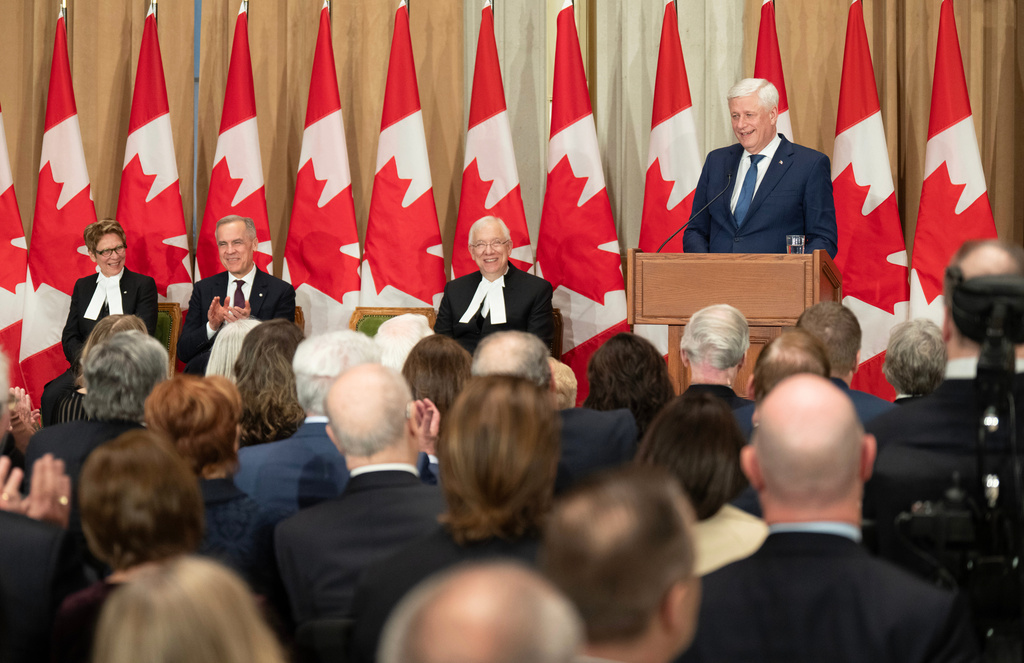 Canada's Speaker of the Senate Raymonde Gagne, from left, Prime Minister Mark Carney and Speaker of the House of Commons Francis Scarpaleggia laugh as former prime minister Stephen Harper delivers his speech during a ceremony marking the unveiling of his official portrait in Ottawa, Ontario, Tuesday, Feb. 3, 2026. (Adrian Wyld/The Canadian Press via AP)