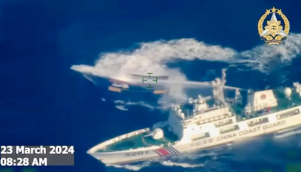FILE - In this image made from video provided by the Armed Forces of the Philippines, a Chinese coast guard ship uses water cannon on a Philippine resupply vessel Unaizah May 4 as it approaches Second Thomas Shoal, locally called Ayungin shoal, at the disputed South China Sea on March 23, 2024. (Armed Forces of the Philippines via AP, File)