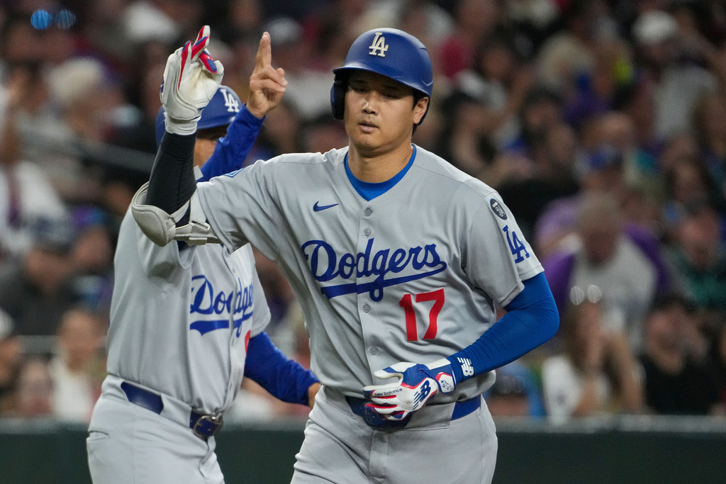 Los Angeles Dodgers' Shohei Ohtani gestures after hitting a home run against the Arizona Diamondbacks during the fourth inning of a baseball game Thursday, Sept. 25, 2025, in Phoenix. (AP Photo/Darryl Webb)