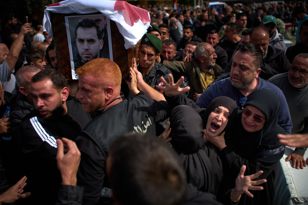 Mourners react during the funeral of 13 state security officers killed the previous day in an Israeli strike in Lebanon's coastal city of Sidon, Saturday, April 11, 2026. (AP Photo/Emilio Morenatti)