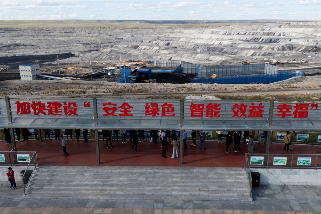 A viewing platform with the slogan "Accelerate the building of safe, sustainable, intelligent, benefit and happiness" at the Huaneng Yimin open-pit coal mine in Hulunbuir in northern China's Inner Mongolia province China, Monday, Sept. 15, 2025. (AP Photo/Ng Han Guan)