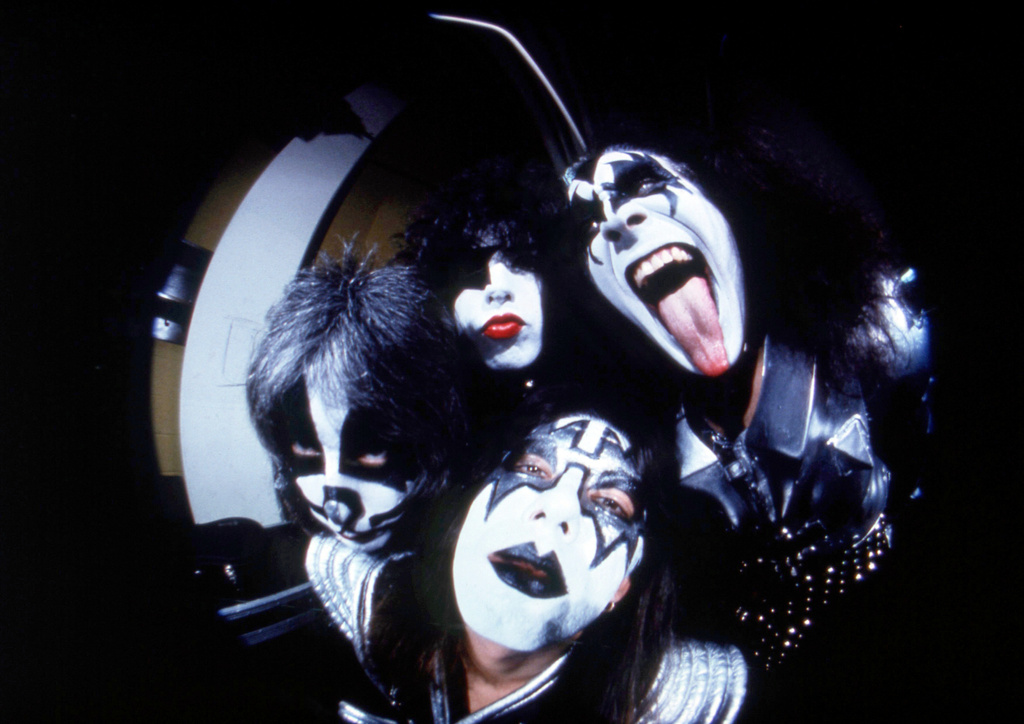 FILE - In this image taken with a fisheye lens, members of the rock group Kiss, clockwise from right, Gene Simmons,, Ace Frehley, Peter Criss and Paul Stanley pose before a concert in Hartford, Conn., Feb. 16, 1977. (AP Photo/Richard Drew, File)