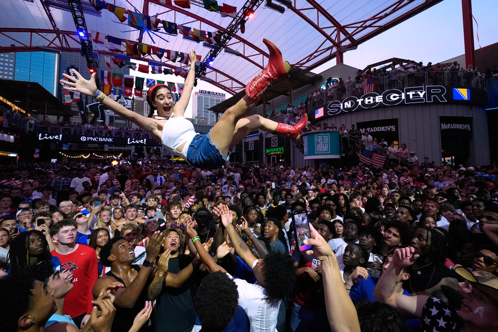Fans celebrate during a watch party for a World Cup soccer match against Bosnia at the KC Live! entertainment district Wednesday, July 1, 2026, in Kansas City, Mo. (AP Photo/Charlie Riedel)