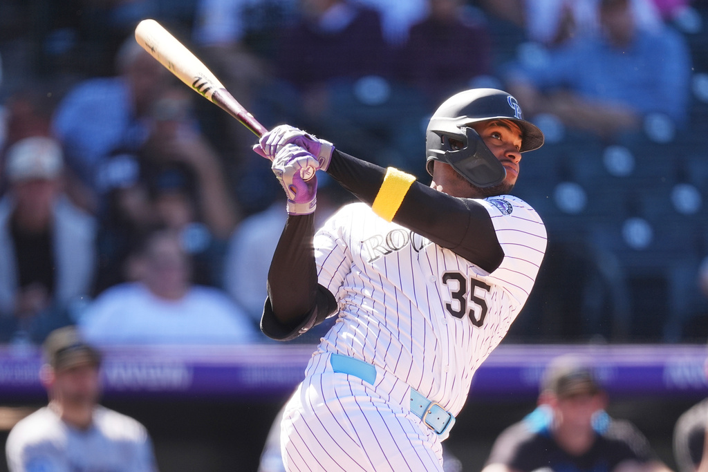Colorado Rockies' Yanquiel Fernández hits a solo home run off Miami Marlins starting pitcher Sandy Alcantara in the seventh inning of a baseball game Thursday, Sept. 18, 2025, in Denver. (AP Photo/David Zalubowski)