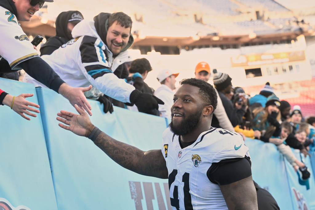 Jacksonville Jaguars defensive end Josh Hines-Allen high fives fans after defeating the Tennessee Titans in an NFL football game Sunday, Nov. 30, 2025, in Nashville, Tenn. (AP Photo/John Amis)