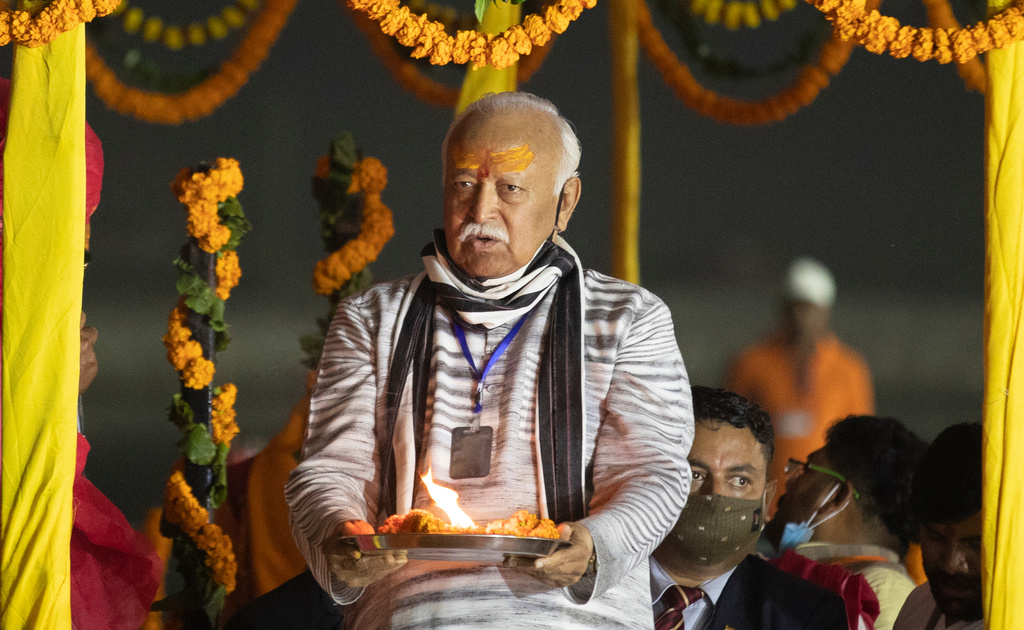 FILE - Hindu nationalist Rashtriya Swayamsevak Sangh (RSS) chief Mohan Bhagwat offers prayers at Sangam, the confluence of the rivers Ganges and the Yamuna and mythical Saraswati rivers, at the annual traditional fair of Magh Mela in Prayagraj, India, Friday, Feb. 19, 2021. (AP Photo/Rajesh Kumar Singh, File)