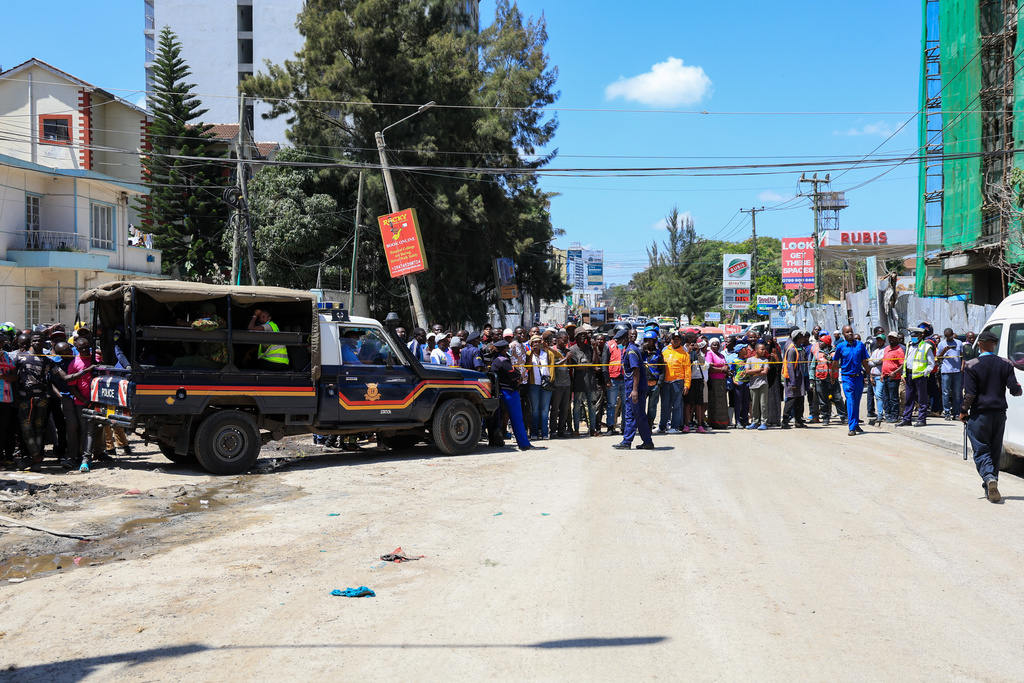 People gather near the scene of the collapsed building in Nairobi, Kenya, Friday, Jan. 2, 2026. (AP Photo/Andrew Kasuku)