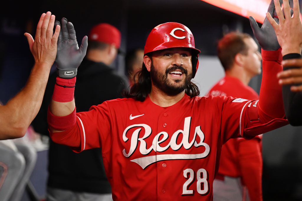 Cincinnati Reds designated hitter Eugenio Suarez (28) celebrates in the dugout after hitting a solo home run against the Toronto Blue Jays during the second inning of a baseball game in Toronto, Friday, Sept. 25, 2026. (Jon Blacker/The Canadian Press via AP)