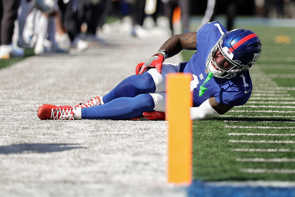 New York Giants wide receiver Malik Nabers (1) reacts to an injury during the second quarter of an NFL football game against the Los Angeles Chargers, Sunday, Sept. 28, 2025, in East Rutherford, N.J. (AP Photo/Adam Hunger)