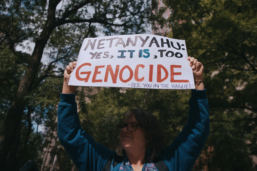 A demonstrator holds a placard near United Nations headquarters during a protest against Israeli Prime Minister Benjamin Netanyahu on Thursday, Sept. 24, 2026, in New York. (AP Photo/Andres Kudacki)