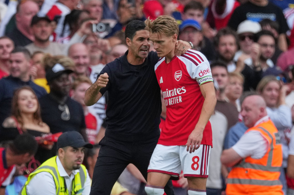 Arsenal's manager Mikel Arteta talks to Arsenal's Martin Odegaard during the English Premier League soccer match between Arsenal and Chelsea in London, Sunday, Sept. 6, 2026. (AP Photo/Dave Shopland)