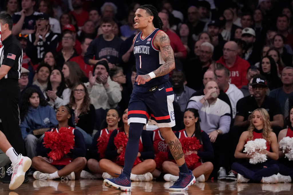 UConn guard Solo Ball (1) reacts after scoring during the first half of an NCAA college basketball game against St. John's in the championship of the Big East tournament, Saturday, March 14, 2026, in New York. (AP Photo/Yuki Iwamura)
