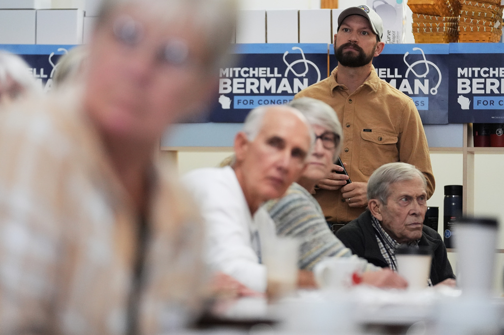 Democratic congressional candidate Mitchell Berman listens to supporter at Wilson's Coffee and Tea in Racine, Wis., Tuesday, Sept. 22, 2026. (AP Photo/Nam Y. Huh)