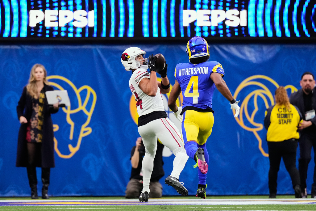 CORRECTS NAME TO MICHAEL WILSON NOT COBIE DURANT - Arizona Cardinals wide receiver Michael Wilson, left, catches a pass for a touchdown in front of Los Angeles Rams cornerback Ahkello Witherspoon (4) during the second half of an NFL football game, Sunday, Jan. 4, 2026, in Inglewood, Calif. (AP Photo/Mark J. Terrill)