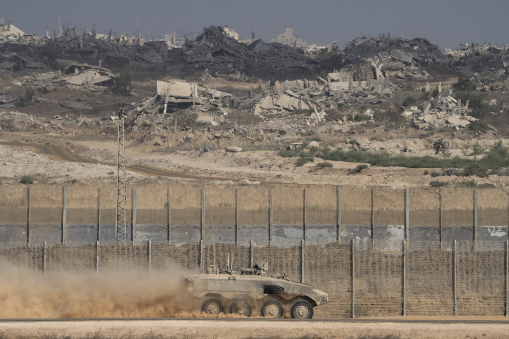An Israeli armored personnel carrier (APC) moves along the Israeli-Gaza border, as seen from southern Israel, Tuesday, Aug. 26, 2025. (AP Photo/Maya Levin)