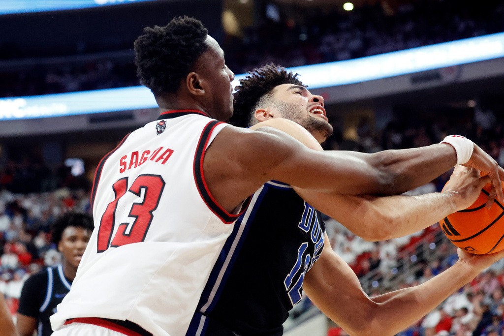 Duke's Cameron Boozer, right, battles for the ball with North Carolina State's Musa Sagnia (13) during the second half of an NCAA college basketball game in Raleigh, N.C., Monday, March 2, 2026. (AP Photo/Karl DeBlaker)