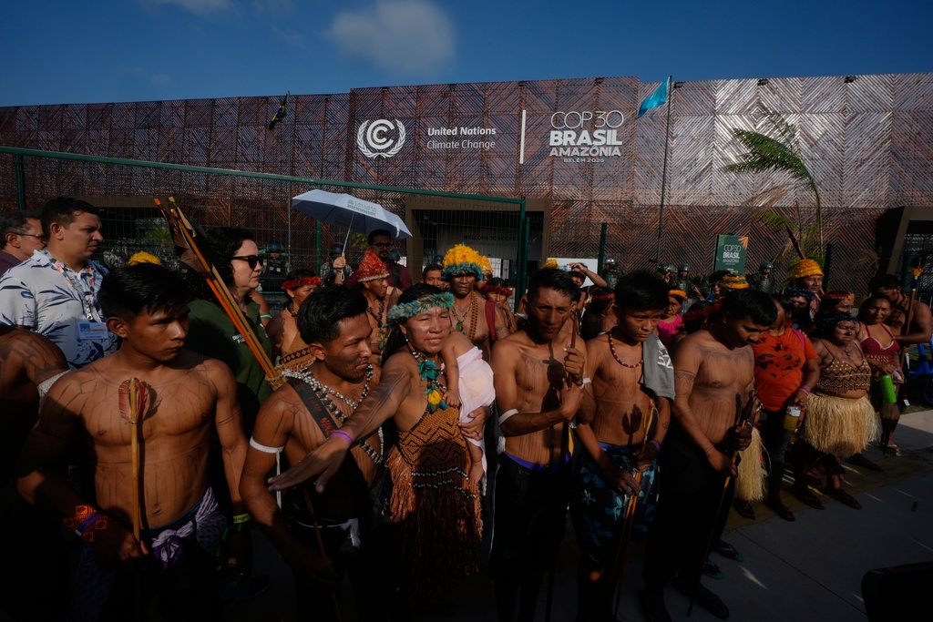 An Indigenous group blocks an entrance to the COP30 U.N. Climate Summit, Friday, Nov. 14, 2025, in Belem, Brazil. (AP Photo/Fernando Llano)