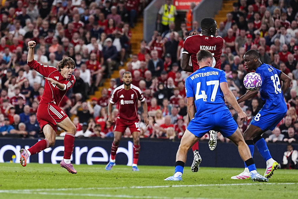Liverpool's Federico Chiesa, left, scores their side's third goal of the game during the English Premier League soccer match between Liverpool and Bournemouth at Anfield, Liverpool, England, Friday Aug. 15, 2025. (Peter Byrne/PA via AP)