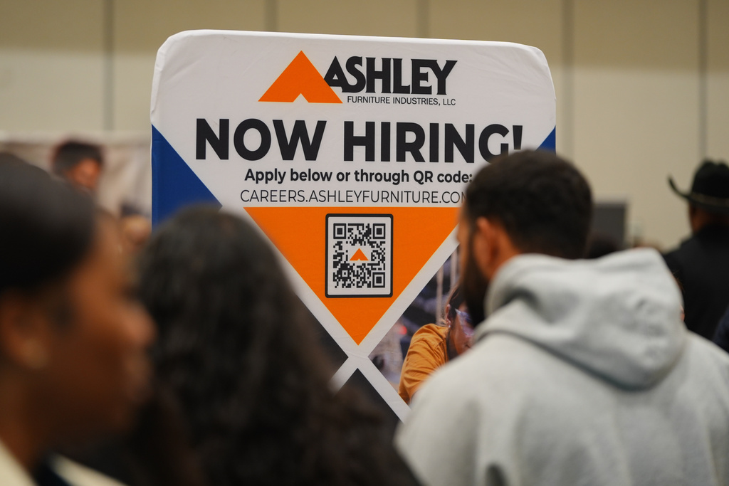 FILE - A sign with information about employment is displayed during a job fair in Dallas, Jan. 14, 2026. (AP Photo/LM Otero, File)