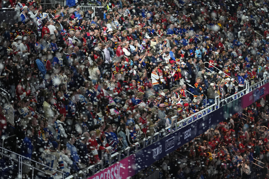 Fans watch before the NHL Winter Classic outdoor hockey game between the Florida Panthers and the New York Rangers, Friday, Jan. 2, 2026, in Miami. (AP Photo/Rebecca Blackwell)