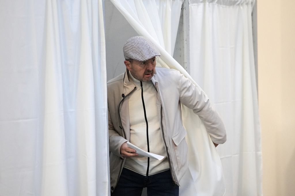 A man prepares to cast his ballot at a polling station in Budapest, Hungary, Sunday, April 12, 2026. (AP Photo/Petr David Josek)