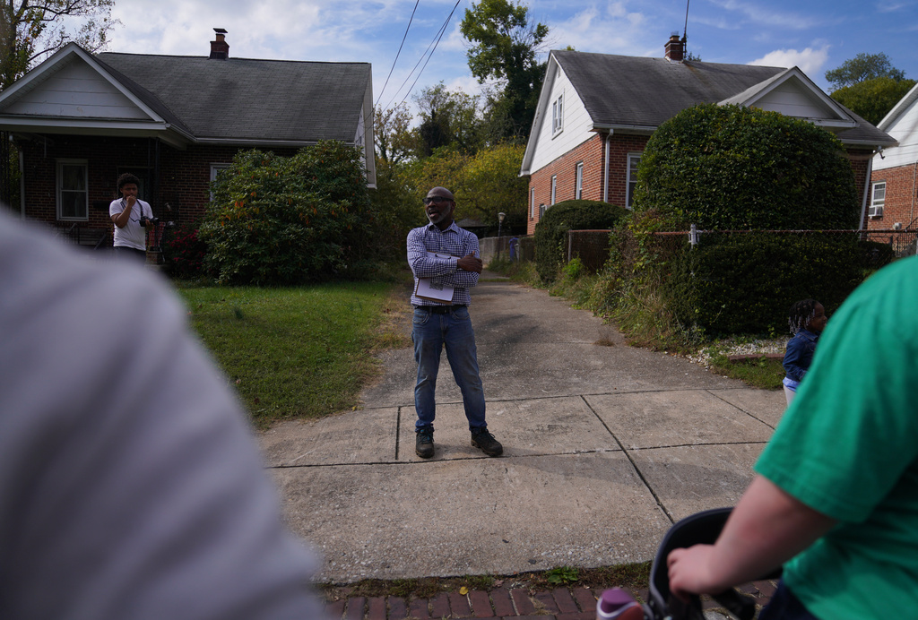 Ulysses Archie, founder of the small nonprofit the Baltimore Gift Economy, leads a walking tour of Collins Avenue in Baltimore, Sunday, Oct. 19, 2025, as part of the Baltimore Gift Economy's third annual "Finding Home" gathering. (AP Photo/Jessie Wardarski)