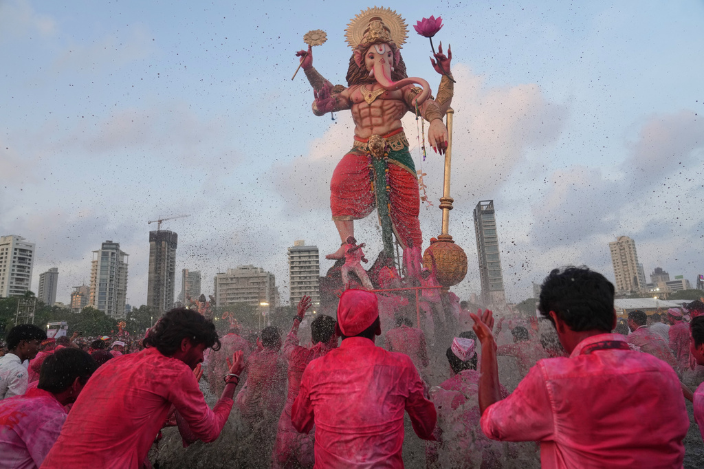 Devotees prepare to immerse an idol of elephant-headed Hindu god Ganesha in the Arabian Sea, marking the end of the 10-day long Ganesh Chaturthi festival in Mumbai, India, Friday, Sept. 25, 2026. (AP Photo/Rafiq Maqbool)