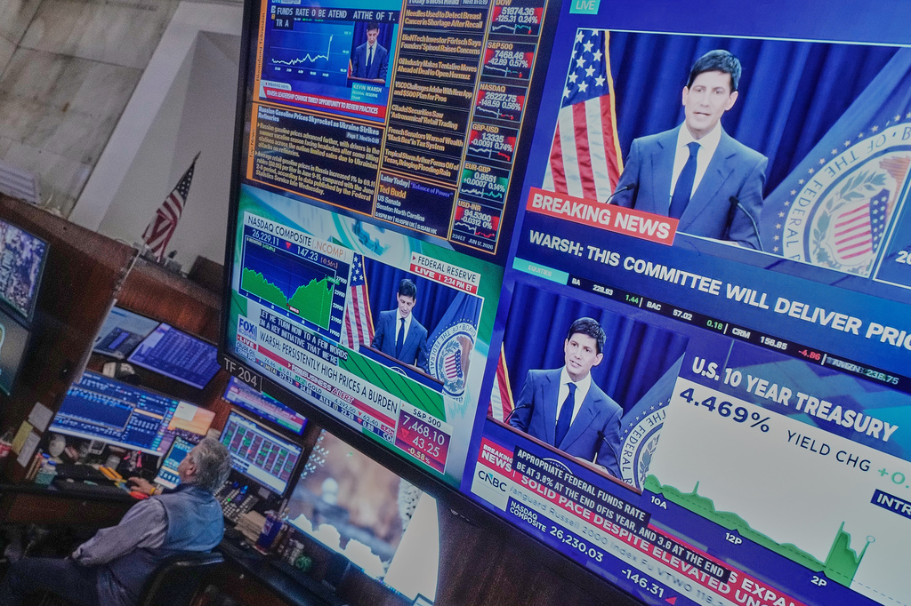 Federal Reserve Chair Kevin Warsh's press conference appears on screens on the floor of the New York Stock Exchange, Wednesday, June 17, 2026. (AP Photo/Richard Drew)