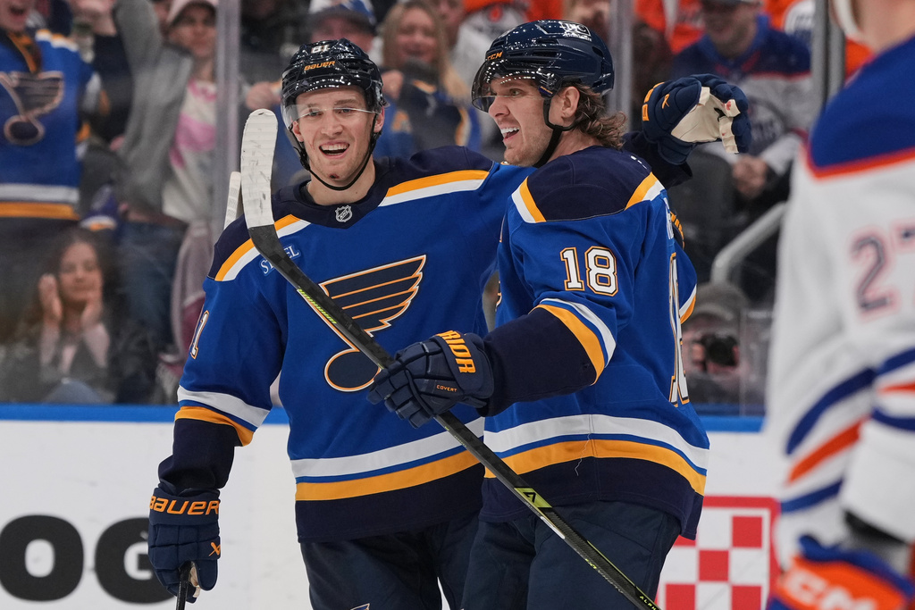 St. Louis Blues' Robert Thomas (18) is congratulated by Dylan Holloway after scoring during the second period of an NHL hockey game against the Edmonton Oilers Monday, Nov. 3, 2025, in St. Louis. (AP Photo/Jeff Roberson)