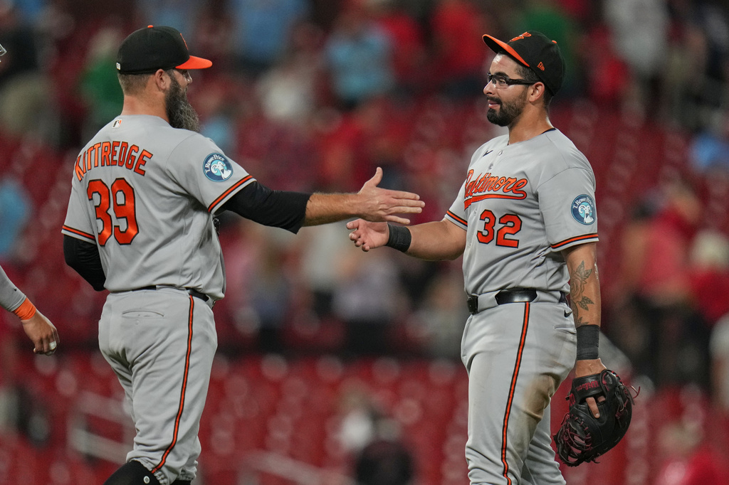 Baltimore Orioles' Christian Encarnacion-Strand (32) and Andrew Kittredge (39) celebrate a victory over the St. Louis Cardinals following a baseball game Wednesday, Aug. 26, 2026, in St. Louis. (AP Photo/Jeff Roberson)