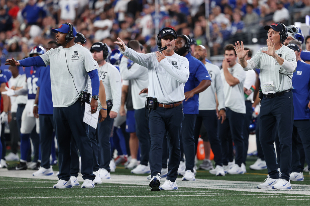 New York Giants head coach John Harbaugh, center, reacts during the first half of an NFL football game against the Dallas Cowboys, Sunday, Sept. 13, 2026, in East Rutherford, N.J. (AP Photo/Pamela Smith)