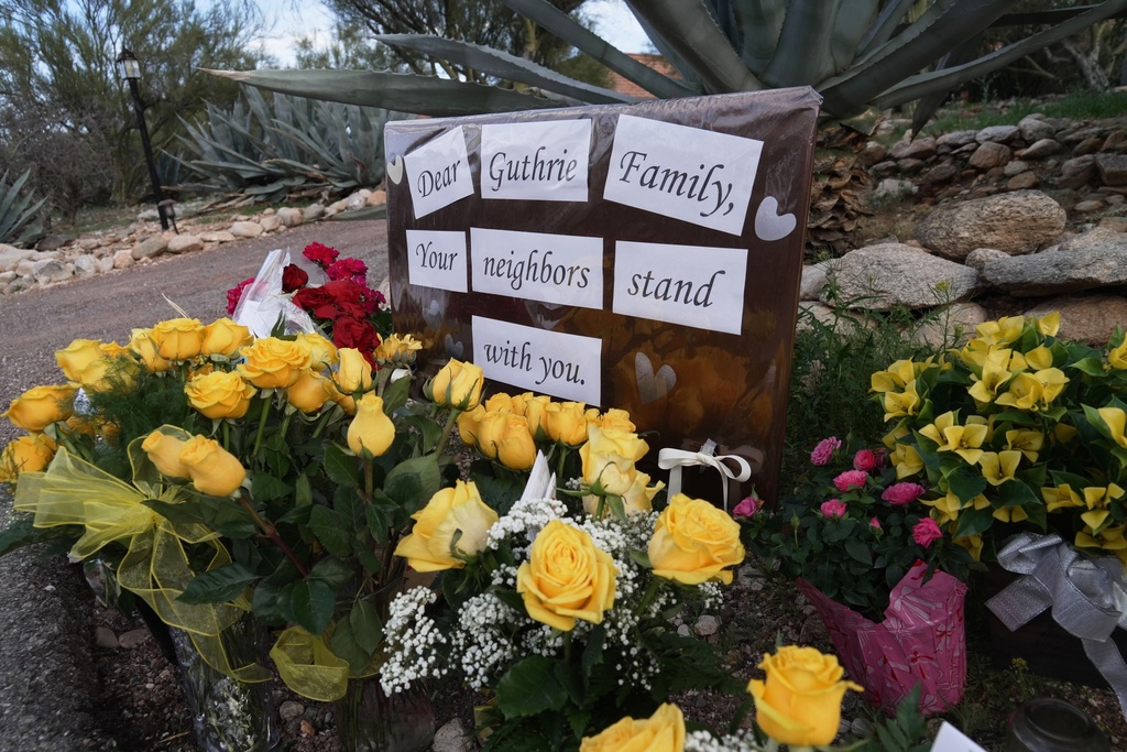 A small vigil grows near Nancy Guthrie's house, Wednesday, Feb. 11, 2026 in Tucson, Ariz. (AP Photo/Ty ONeil)