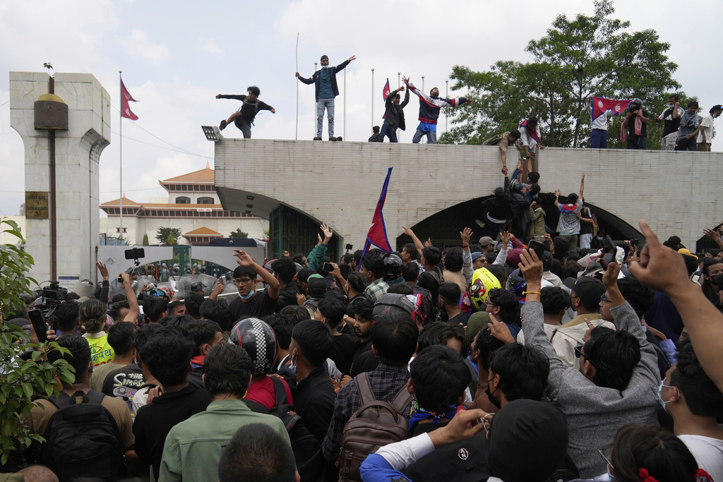 Protesters shout slogans as they gather outside the Parliament building in Kathmandu, Nepal, Monday, Sept. 8, 2025. (AP Photo/Niranjan Shrestha)