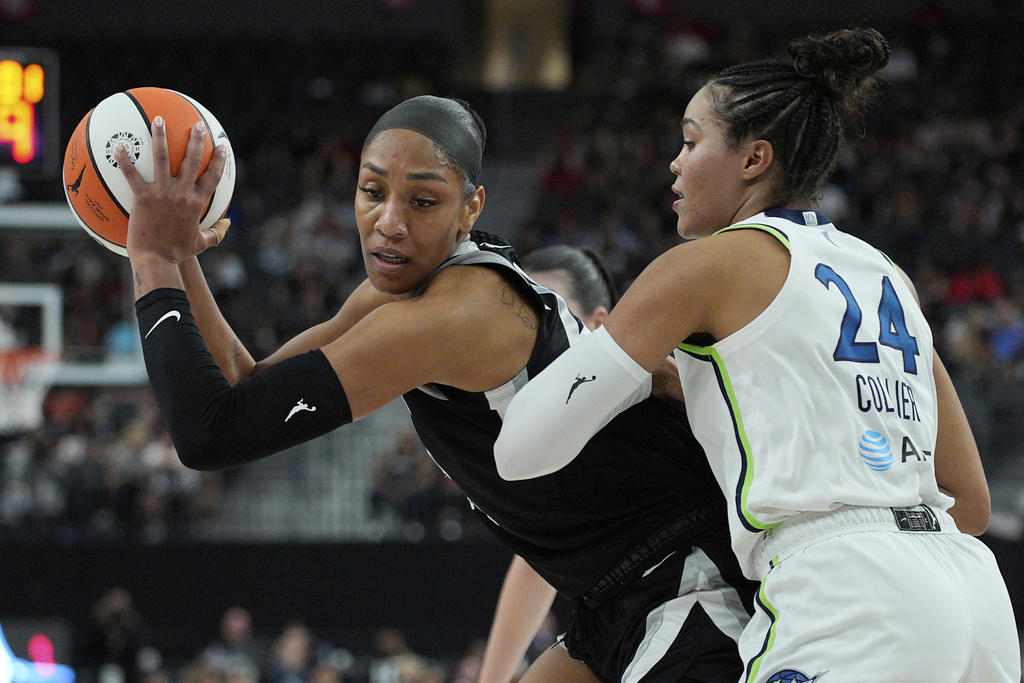 Las Vegas Aces center A'ja Wilson, left, drives against Minnesota Lynx forward Napheesa Collier (24) during the first half of a WNBA basketball game Thursday, Sept. 4, 2025, in Las Vegas. (AP Photo/John Locher)