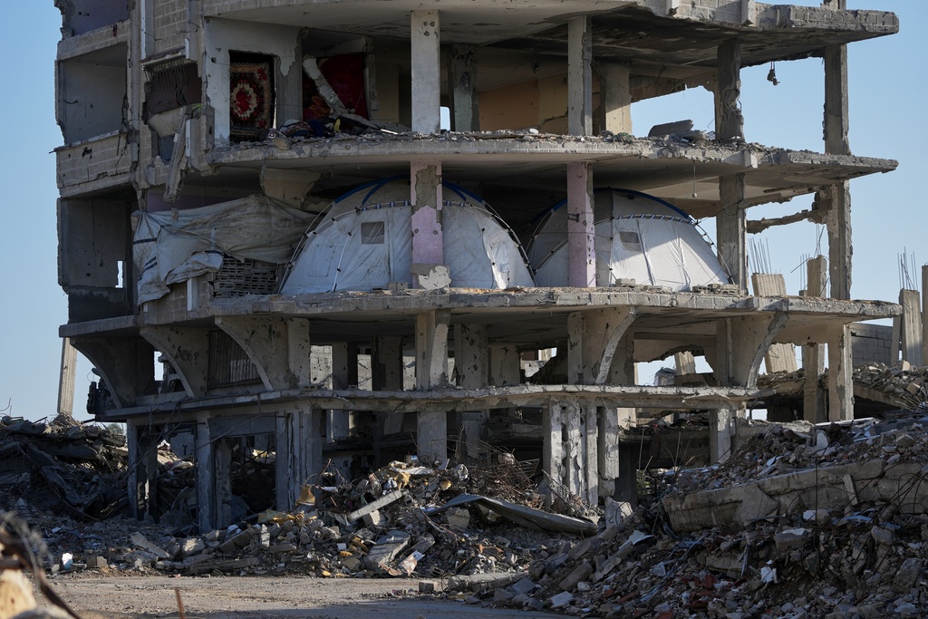 Tents are set up inside a gutted apartment building in Khan Younis, in the southern Gaza Strip, Saturday, Nov. 15, 2025. (AP Photo/Abdel Kareem Hana)