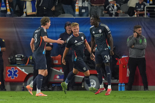 San Diego FC midfielder Onni Valakari, left, celebrates his goal with teammate midfielder Manu Duah, right, and defender Jeppe Tverskov, center, during the first half of Game 1 in the first round of MLS soccer's Western Conference playoff against Portland Timbers Sunday, Oct. 26, 2025, in San Diego. (AP Photo/Gregory Bull) San Diego FC midfielder Onni Valakari, left, celebrates his goal with teammate midfielder Manu Duah, right, and defender Jeppe Tverskov, center, during the first half of Game 1 in the first round of MLS soccer's Western Conference playoff against Portland Timbers Sunday, Oct. 26, 2025, in San Diego. (AP Photo/Gregory Bull)