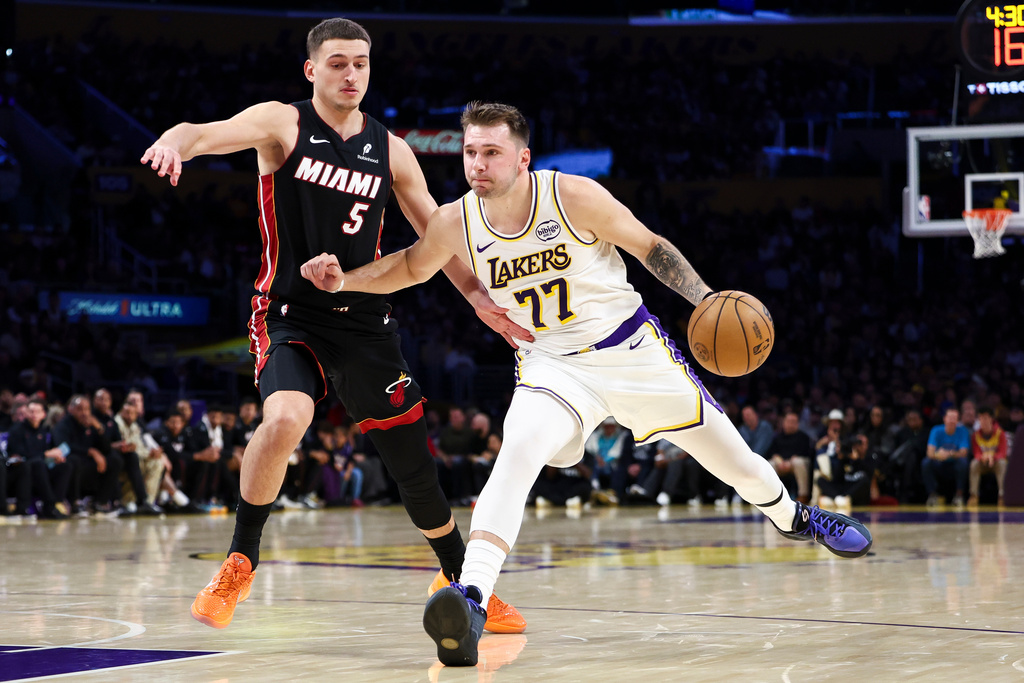 Los Angeles Lakers guard Luka Doncic (77) drives against Miami Heat forward Nikola Jovic (5) during the first half of an NBA basketball game, Sunday, Nov. 2, 2025, in Los Angeles. (AP Photo/Jessie Alcheh)