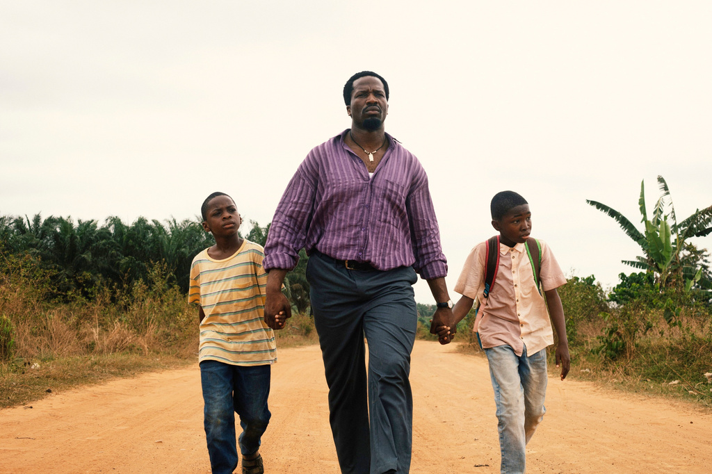 This image released by Mubi shows Godwin Egbo, from left, Ṣọpẹ́ Dìrísù, and Chibuike Marvellous Egbo in a scene from "My Father's Shadow." (Mubi via AP)