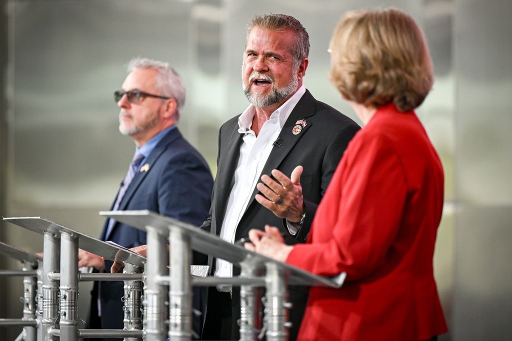 Victor Marx, center, turns to Colorado state Sen. Barbara Kirkmeyer, right, while Colorado state Rep. Scott Bottoms, left, looks on during a Republican gubernatorial debate, June 2, 2026, in Denver. (Aaron Ontiveroz/The Denver Post via AP)