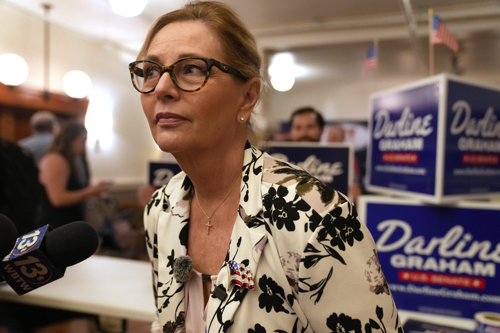 Sen. Darline Graham, R-S.C., leans over to hear a reporter's question following at a candidate event for hopefuls vying in a special Republican primary to replace her late brother Sen. Lindsey Graham, R-S.C., on November ballots, Saturday, Aug. 8, 2026, in Florence, S.C. (AP Photo/Meg Kinnard)